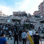 Buried Eight Days—He Still Walked Out People at a collapsed building after an earthquake.