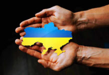 Power Play in Kyiv—PM Pick Stuns Hands holding Ukraine map with flag design.