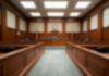 Empty courthouse courtroom with wooden benches and chairs.