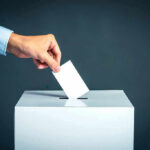 California Loophole: Sex Offenders Can Still Run Hand placing ballot into voting box.