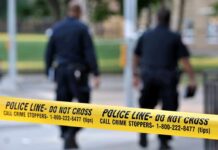 Church Parking Lot Arsenal Stuns Cops Police officers walking past caution tape at a crime scene