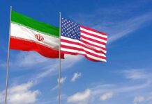 U.S. Hammers Iran Iran and United States flags waving on flagpoles