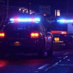 Motel Manager Banked On Children, Feds Say Police cars with flashing lights at a nighttime scene near a motel
