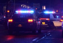 Motel Manager Banked On Children, Feds Say Police cars with flashing lights at a nighttime scene near a motel