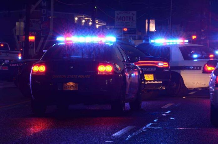 Roseburg,Oregon,-,December,17:,Police,Cars,At,Incident,Where Police cars with flashing lights at a nighttime scene near a motel