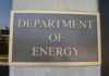 Gates’ Q Clearance Bombshell Department of Energy sign on building wall