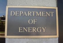 Gates’ Q Clearance Bombshell Department of Energy sign on building wall