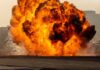 A large explosion creating a massive fireball and smoke
