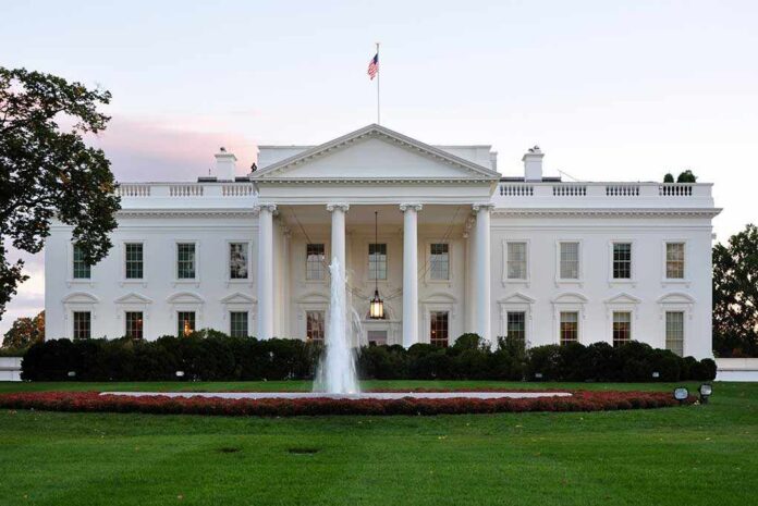 White,House,In,Washington,,Dc,,Usa. The White House with a fountain in the foreground and an American flag flying