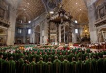 Clergy in green vestments gather under a grand baroque canopy in a vast cathedral