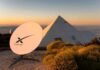 SpaceX’s Orbital AI Gambit Alarms Engineers Starlink satellite dish near a pyramid-shaped building at sunset
