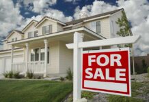 Hidden Landlords Jack Rents, Evict Faster A suburban house with a For Sale sign in the front yard