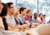 UC Riverside Picks Winners— US Citizens Excluded? A diverse group of students attentively listening in a classroom setting