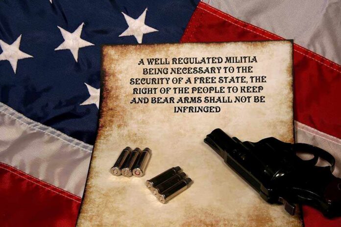 Pistol,Ammo,And,Second,Ammendment,On,The,American,Flag A revolver and bullets placed on an aged document with the Second Amendment text, set against an American flag background