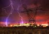 Hybrid War Watch: Poland On Edge Lightning strikes illuminate a power station against a colorful sunset sky
