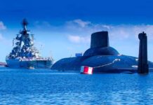 Strait Takeover? Trump Dangles Tolls A submarine and a warship in the ocean under a blue sky