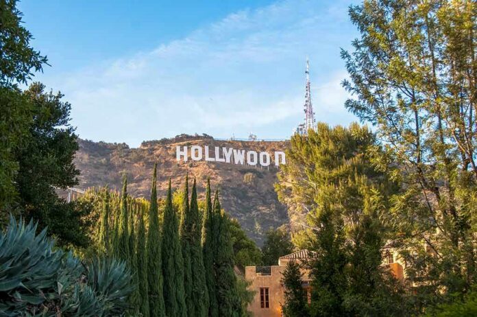 shutterstock_1164563563 Hollywood Sign on hillside framed by trees