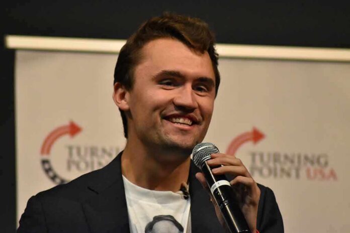 man speaking into a microphone on stage