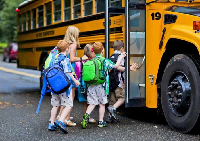 shutterstock_153645101 Children boarding a yellow school bus