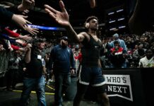 Dress-Down Drama Erupts At WNBA Game Basketball player in headphones high-fives fans while walking past crowd