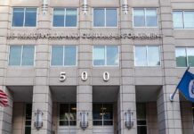 Flip-Flop Firestorm Engulfs Klobuchar US government building facade with flags and number 500