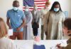 Republicans Torpedo Trump’s Election Crackdown Voters wearing masks stand in line at a polling station