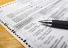 Citizen-Only Voting Push — What’s The Catch? Ballot paper with pen on wooden surface