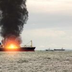 Attack Off Yemen — Trade Routes Unraveling Cargo ship on fire with thick black smoke at sea