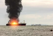Attack Off Yemen — Trade Routes Unraveling Cargo ship on fire with thick black smoke at sea