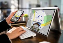 Antitrust Bombshell Rocks Zillow, Redfin Person using phone and laptop with real estate map app