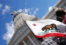 California state flag in front of a white domed capitol building