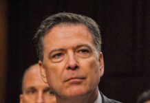 man in suit at a hearing