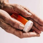 Silent Antidepressant Trap Exposed Older hands holding a prescription pill bottle
