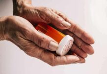 Silent Antidepressant Trap Exposed Older hands holding a prescription pill bottle