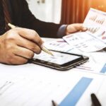 TRILLIONAIRE Hype — Where’s Musk’s Paperwork? Businessperson analyzing charts with tablet and papers