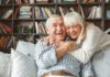 Older couple hugging and laughing on a couch