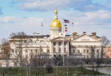 capitol building with gold dome and flags