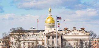 capitol building with gold dome and flags