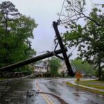 NYC Braces: EMERGENCY Storm Threat Fallen utility poles blocking a wet suburban street