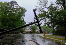 NYC Braces: EMERGENCY Storm Threat Fallen utility poles blocking a wet suburban street