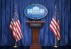 FBI Probes, Systems Fail White House press podium with microphones and two American flags