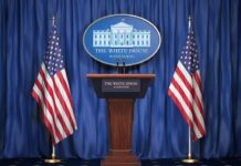 FBI Probes, Systems Fail White House press podium with microphones and two American flags