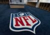 Ponzi Shock: Travis Kelce Named Victim NFL logo on the floor of an empty locker room