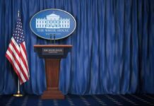 TV Pool Walkout Shocks Washington White House press briefing podium with U.S. flag and blue curtain