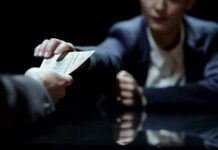Hands exchanging cash across a table