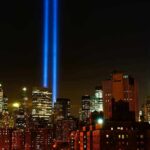 New York City skyline at night with twin blue light beams