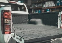 Price Surge Triggers Pickup Truck Repair Boom Pickup truck bed with open tailgate in a workshop