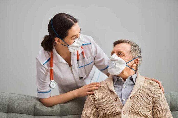 nurse with stethoscope comforting elderly man wearing masks