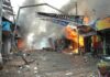 Street marketplace engulfed in fire and heavy smoke