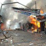 Missile Barrage Ignites Citywide Chaos Street marketplace engulfed in fire and heavy smoke